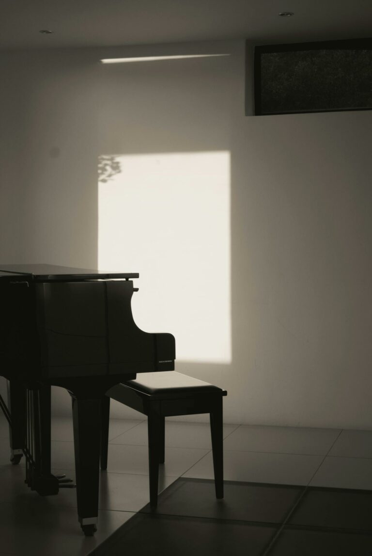 A modern interior with a piano bathed in sunlight, creating a serene ambiance.